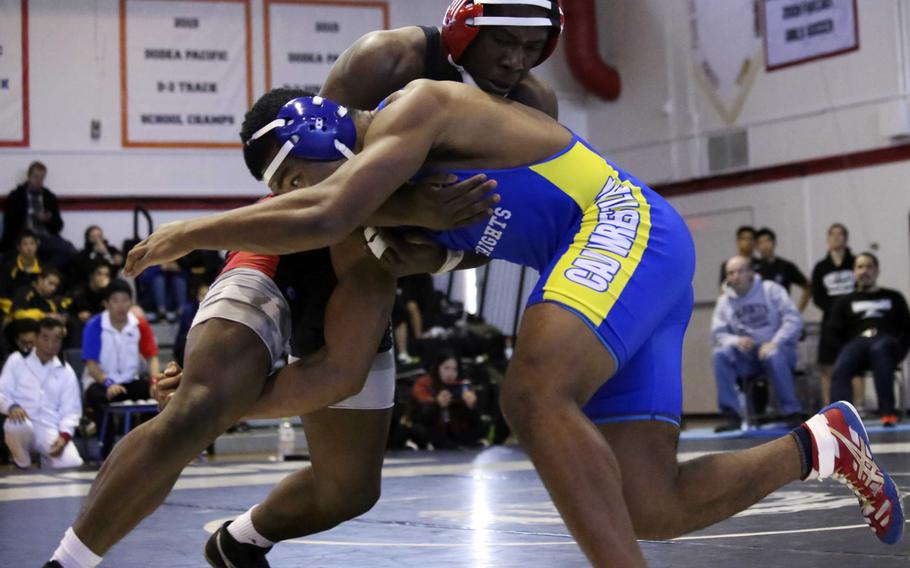 Nile C. Kinnick's Dwayne Lyon and Christian Academy Japan's Lawrence Yamaguchi tangle at 180 pounds during Saturday's Zama Invitational. Defending Far East champion Lyon placed second and Yamaguchi third in the weight class.