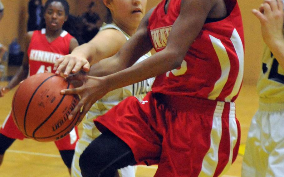 Nile C. Kinnick's Venus Hill goes up for a shot past American School In Japan defender Lexi Howe during Saturday's girls championship game in the ASIJ Kanto Classic basketball tournament. The Red Devils beat the host Mustangs 36-28.