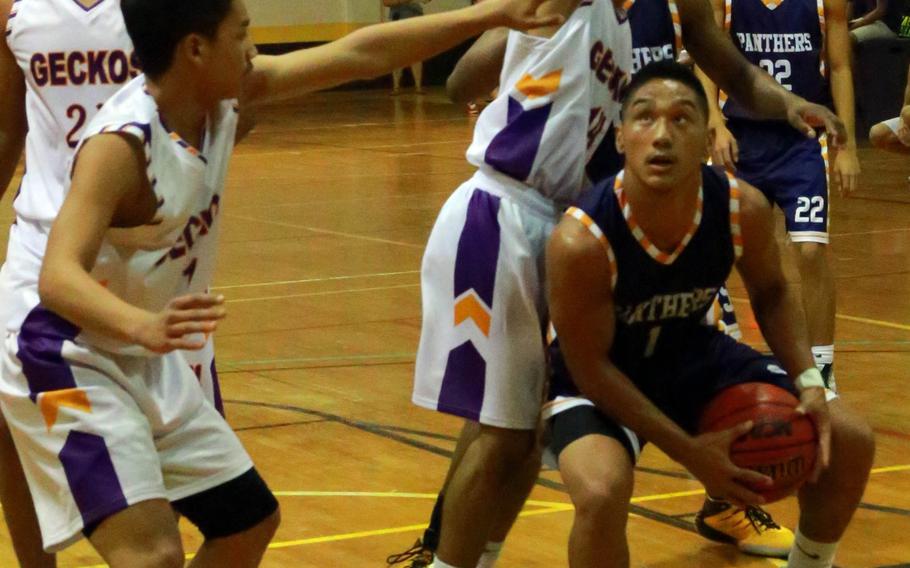 Guam High's Juan King Jr. looks for operating room against the George Washington defense during Tuesday's boys basketball game, won by the visiting Panthers 71-52. Guam High is 5-1 on the season, 1 1/2 games behind St. Paul Christian at 7-0.