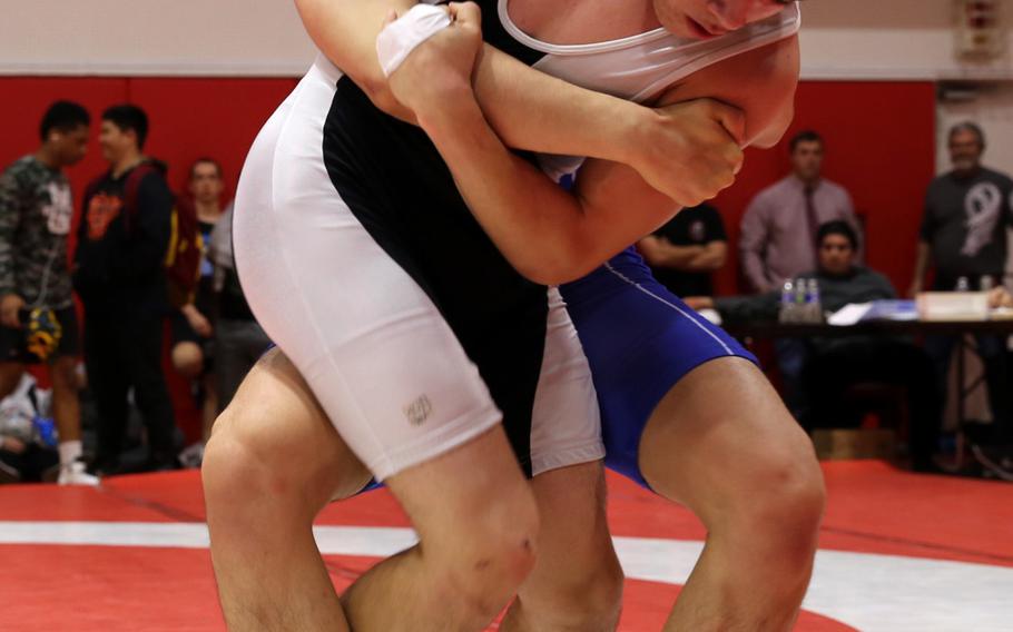 St. Mary's Jihoon Seo and Zama's Curtis Blunt tie each other up in the 148-pound final of Saturday's Kinnick Invitational Tournament. Seo won the bout and the Titans won the team title with 114 points.
