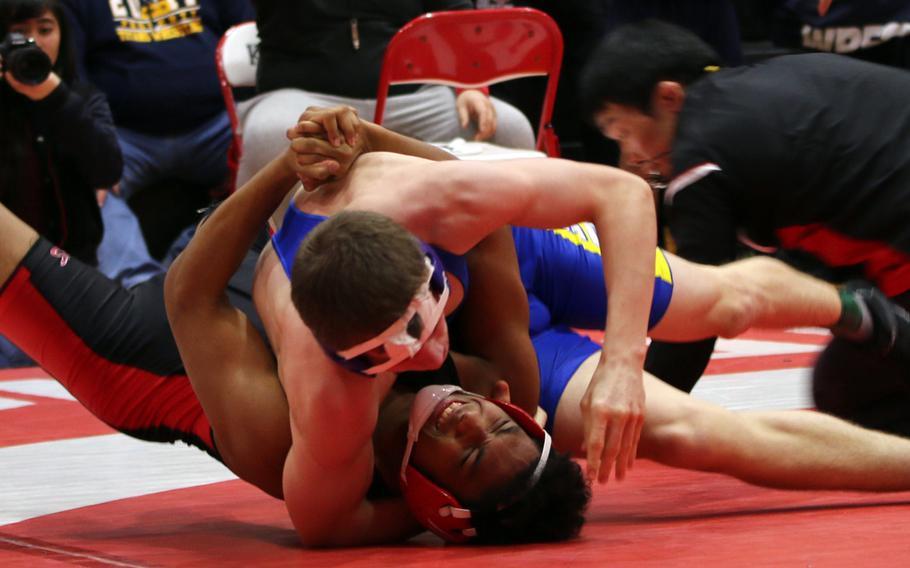 Callum Marshall of Christian Academy Japan gets Nile C. Kinnick's Darius Swenson on his back in the 158-pound final of Saturday's Kinnick Invitational Tournament.Marshall won the bout and the Knights took third in the tournament with 64 points, while the Red Devils were second with 106.