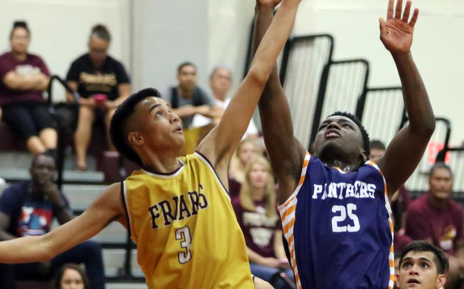 Guam High's Khalid Volious goes up for the ball against Father Duenas' Rudy Gaza during Saturday's Guam boys game. The Friars downed the Panthers 52-41, just the second loss in seven games for Guam.