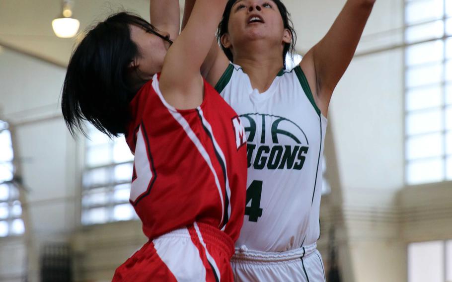 Kubasaki's Eliana Salinas reaches for the ball against Maehara during Saturday's pool-play game in the 11th Okinawa-American Friendship Basketball Tournament. The Dragons lost 41-27, then fell in their first-round playoff game and were relegated to Sunday's consolation round.