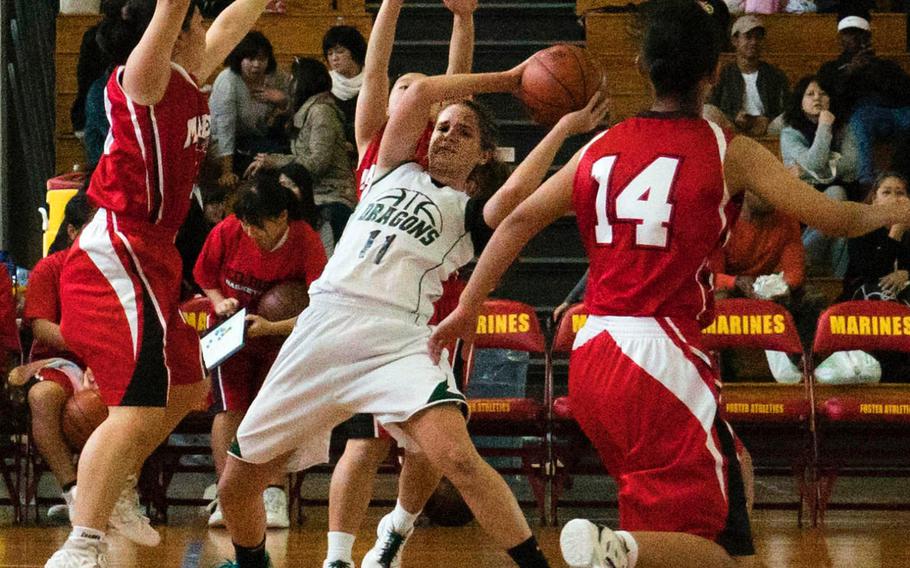 Kubasaki's Chloe' Stevens finds herself trapped by Maehara defenders during Saturday's pool-play game in the 11th Okinawa-American Friendship Basketball Tournament. The Dragons lost 41-27, then lost again in their first-round playoff game to be relegated to Sunday's consolation round.