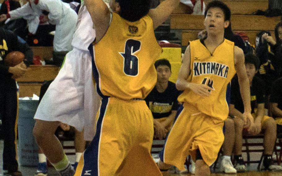 Kubasaki's Elonzo Higginson III shoots over a Kitanakagusuku defender during Saturday's pool-play game in the 11th Okinawa-American Friendship Basketball Tournament. The Dragons edged the Fighting Lions 29-25, then won their first-round playoff game to advance to Sunday's semifinals.