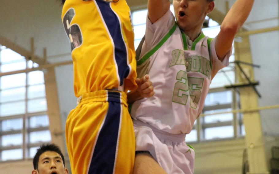 Kubasaki's Jonathan Baker looks for room against the Kitanakagusuku defense during Sunday's championship game in the 11th Okinawa-American Friendship Basketball Tournament. The Dragons lost to the Fighting Lions 63-50.