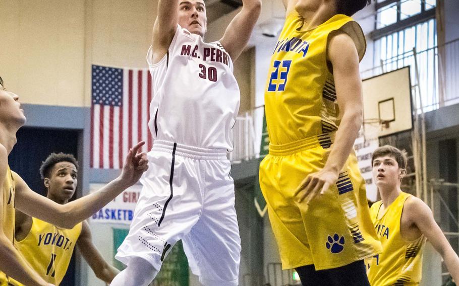 Matthew C. Perry's Garrett Macias shoots over Yokota's Cody Rowan during Thursday's DODEA-Japan tournament play. The host Panthers won 57-48.