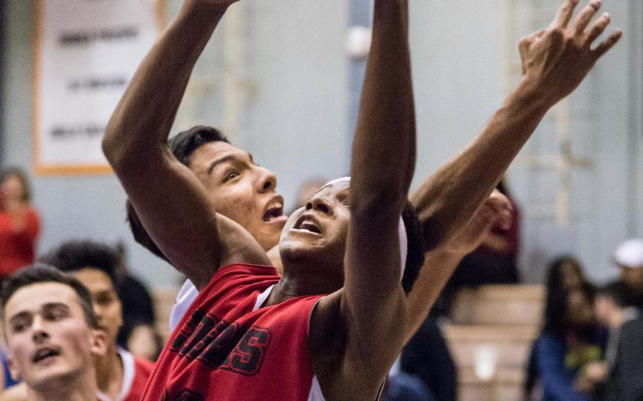 E.J. King's Dyson Robinson and Matthew C. Perry's Jon Armijo battle for the ball during Friday's DODEA-Japan tournament semifinal. The Cobras won 63-36 and face Nile C. Kinnick for the title on Saturday.