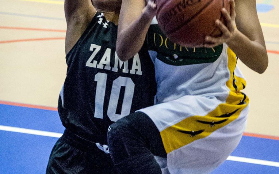 Robert D. Edgren's Coko Magby shoots past Zama's Faith Bryant during Friday's DODEA-Japan tournament semifinal. The Eagles won 46-22 and face Yokota for the title on Saturday.