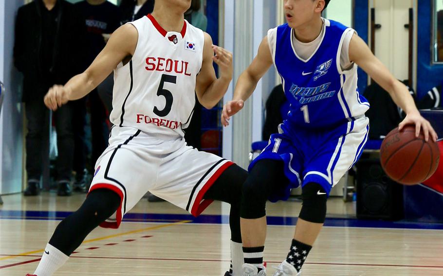 Seoul American freshman Caleb Lee dribbles against Seoul Foreign's Paul Yoon during Friday's Korea Blue tournament semifinal. The Falcons won 83-50 and face Humphreys in Saturday's championship for the second straight year.