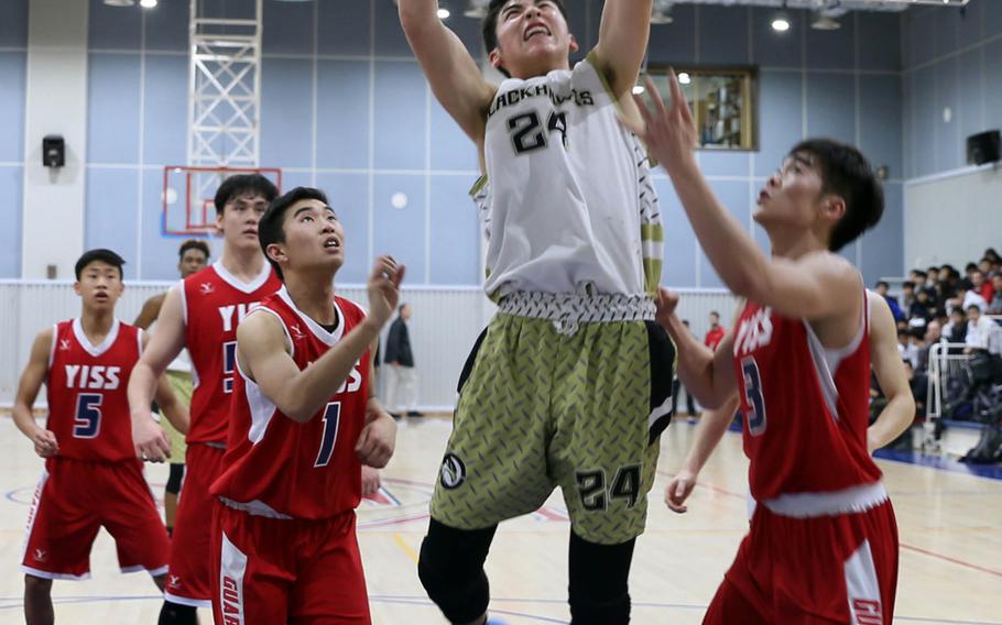 Humphreys' Brice Bulotovich towers over Yongsan International players going for a rebound during Friday's Korea Blue tournament semifinal. The Blackhawks won 77-47 and face Seoul American in Saturday's final for the second straight season.