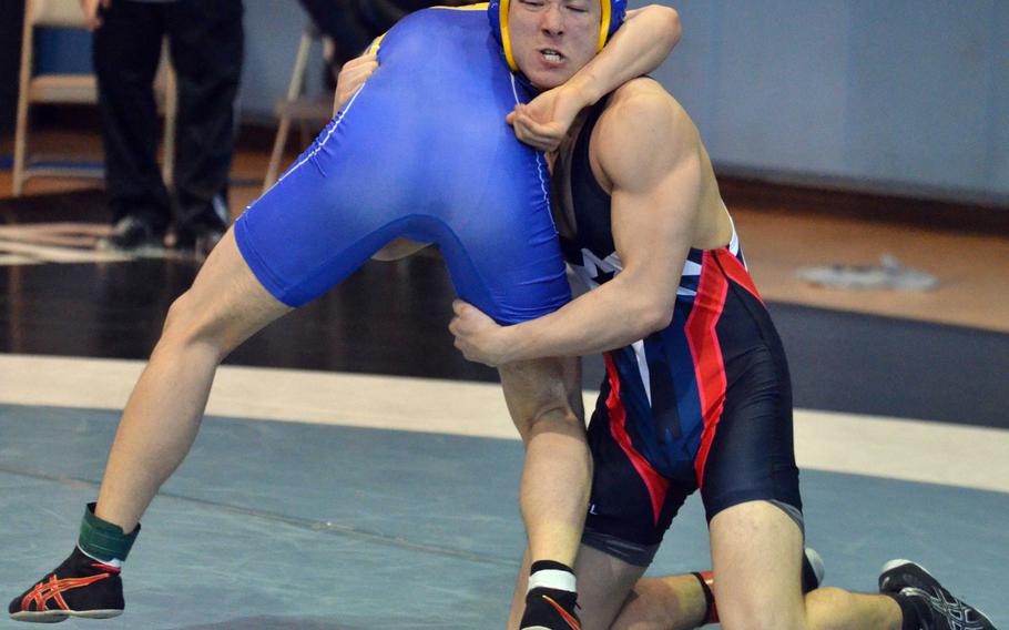 Seoul American's David Messinger readies to lift St. Mary's Jihoon Seo at 148 pounds during Thursday's championship bracket semifinal in the Far East High School Wrestling Tournament. Messinger won by technical fall.