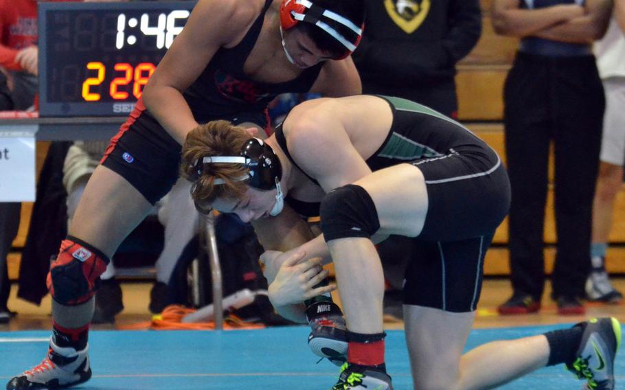 Daegu's Hunter Lane prepares to lift Nile C. Kinnick's Jacob Castro at 148 pounds during Thursday's championship bracket semifinal in the Far East High School Wrestling Tournament. Lane won by technical fall.