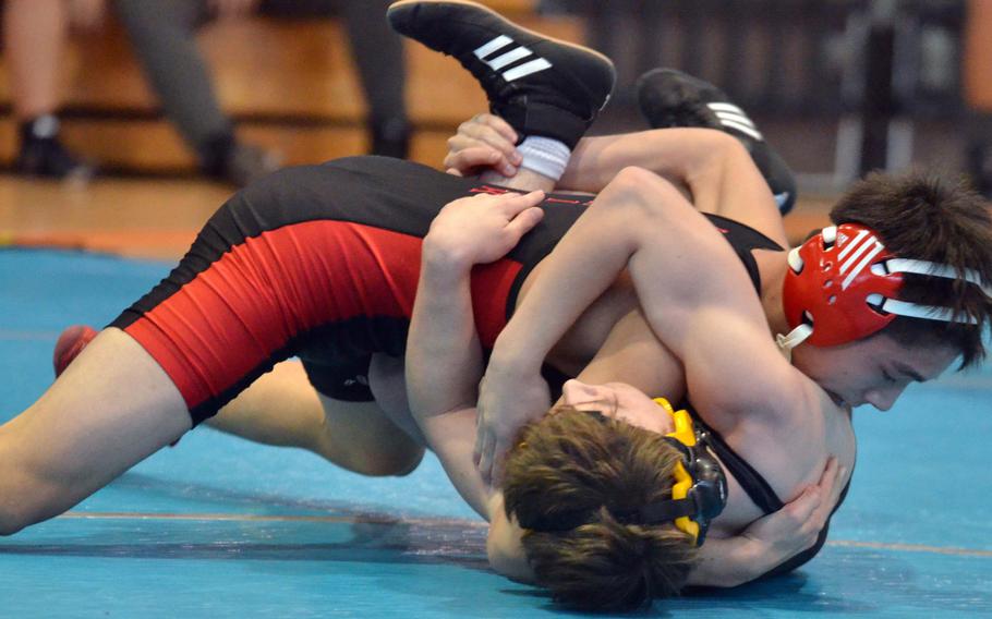 Nile C. Kinnick's Lucas Wirth gains the edge on Kadena's Kaleb Wallace at 122 pounds during Thursday's championship bracket semifinal in the Far East High School Wrestling Tournament. Wirth won by technical fall.