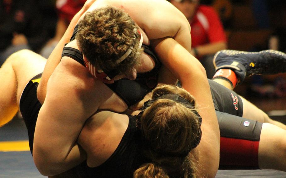 Nile C. Kinnick's Marc Domery gets the advantage on Kadena's James White during Friday's heavyweight championship in the Far East High School Wrestling Tournament. Domery pinned White twice in a two-bout final, in 4:18 and 1:40.