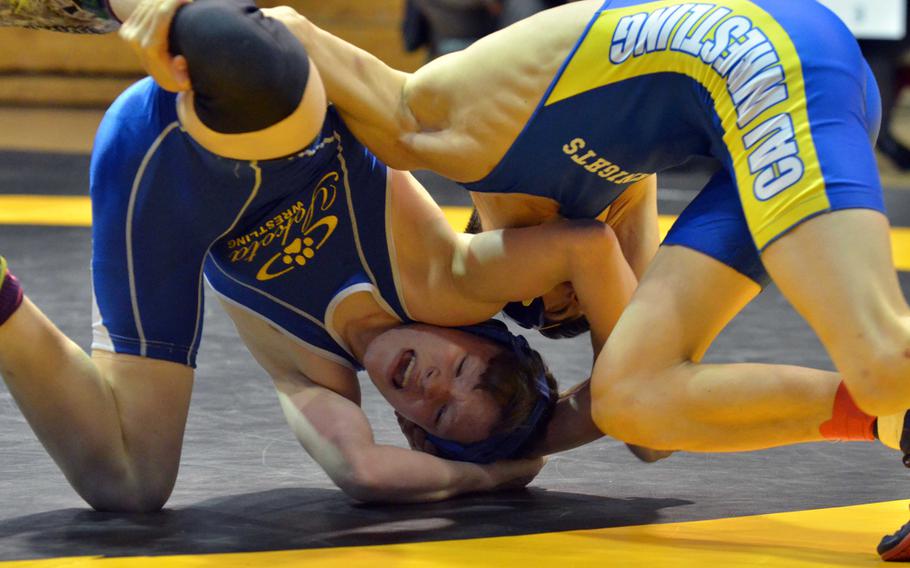 Yokota's Luke Alexander and Christian Academy Japan's Michael Yoshino turn their worlds upside down during Saturday's 122-pound bout in the Far East Wrestling Tournament Division II dual-meet final. Alexander pinned Yoshino in 2 minutes, 1 seconds and Yokota won the meet and its second straight title.