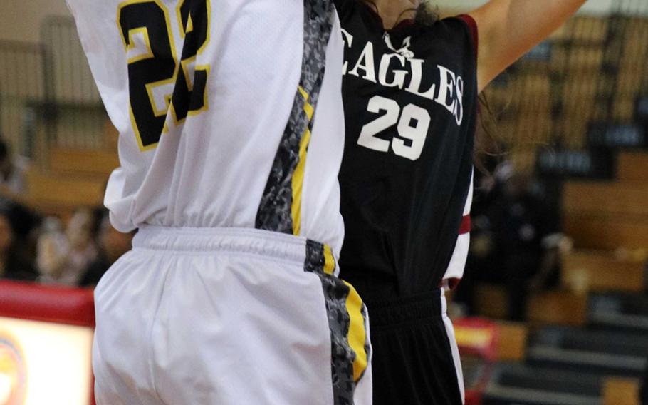 American School of Bangkok's Neeltje Hendriske tries to shoot through the block by Kadena's Isabel Tayag during Monday's pool-play game in the Far East Girls Division I basketball tournament. The Eagles edged the defending champion Panthers 48-45 in double-overtime.