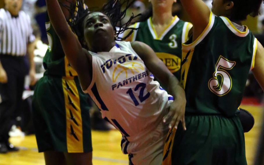 Yokota's Jamia Bailey shoots around Robert D. Edgren's Coko Magby during Monday's pool-play game in the Far East Girls Division II basketball tournament. The Panthers won 38-19.