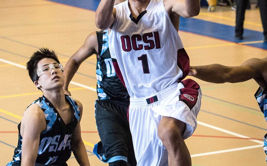 Okinawa Christian's Chris Carney goes up for a shot against the Osan defense during Monday's pool-play game in the Far East Boys Division II Tournament. The Crusaders won 53-45.