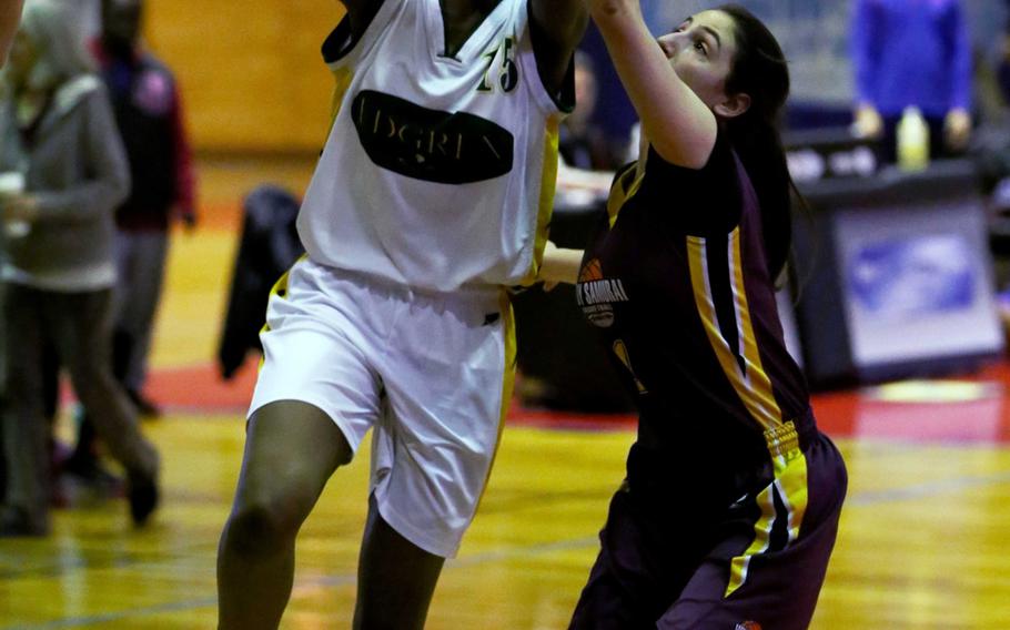 Robert D. Edgren's Ja'la Wade shoots past Matthew C. Perry's Lebet Erhart during Wednesday's semifinal in the Far East Girls Division II Basketball Tournament. The Eagles grounded the Samurai 43-34.