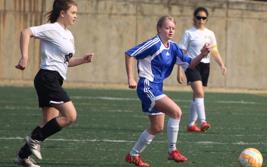 Seoul American's Any Arnold dribbles between two Humphreys defenders during Saturday's season-opening Korea blue match, won by the host Falcons 1-0.