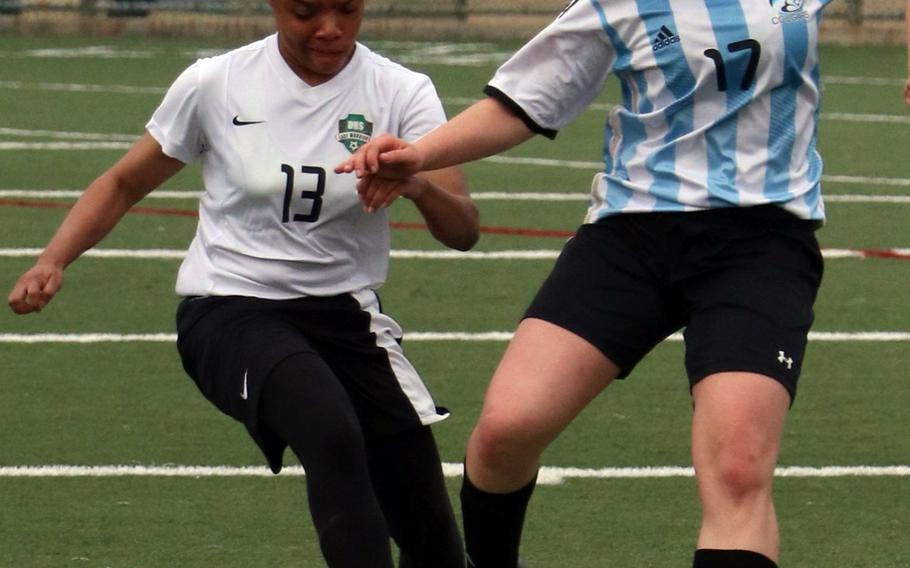 Daegu's Mylisse Spurgon and Osan's Elizabeth White battle for the ball during Saturday's season-opening Korea Blue soccer match, won by the Cougars 5-0.