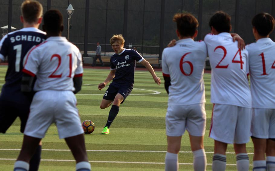 Seoul American's T.J. Carver readies a free kick against the Yongsan's wall during Wednesday's boys soccer match. The host Guardians won 6-4.