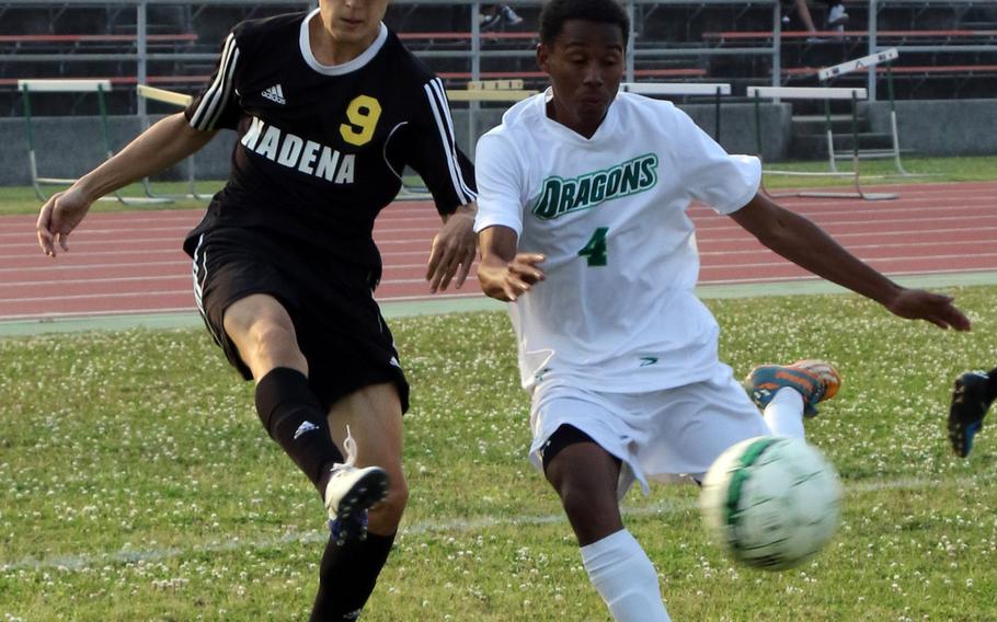 Kadena's Kian Smith blasts a shot past Kubasaki's Emmanuel Wilson into the net for the Panthers lone goal of Wednesday's boys soccer match; the Dragons rallied for two second-half goals to win 2-1.