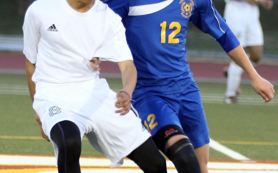 Robert D. Edgren's Jun Royster and Yokota's Keanu McElroy battle for the ball during Friday's boys soccer game, won by the visiting Panthers 6-0.