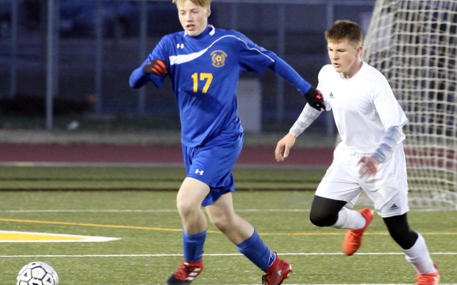 Yokota's Dakota Peltzer and Robert D. Edgren's Cody Dettman chase the ball during Friday's boys soccer game, won by the visiting Panthers 6-0.