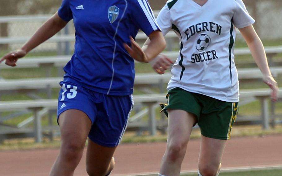 Yokota's Regina Dukat and Robert D. Edgren's Aylin Blackwell chase the ball during Friday's girls soccer game, won by the visiting Panthers 8-0.