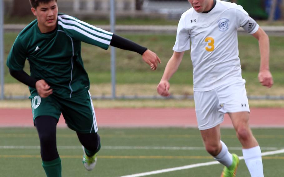 Yokota's Dylan Grimes plays the ball against Robert D. Edgren's Benjamin Christenson during Saturday's boys soccer game.