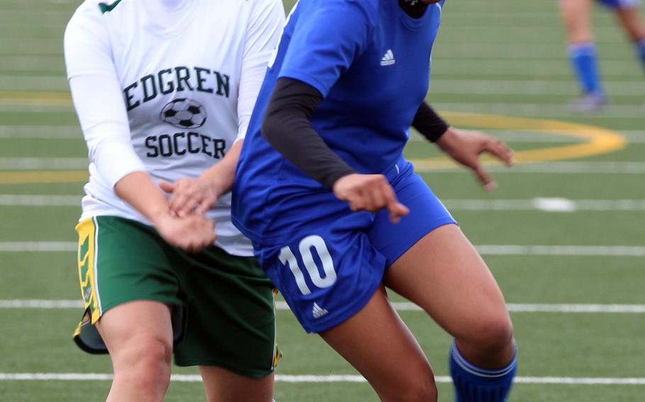 Robert D. Edgren's Victoria Lucero and Yokota's Ai Robbins battle for the ball during Saturday's girls soccer game, won by the visiting Panthers 4-0.