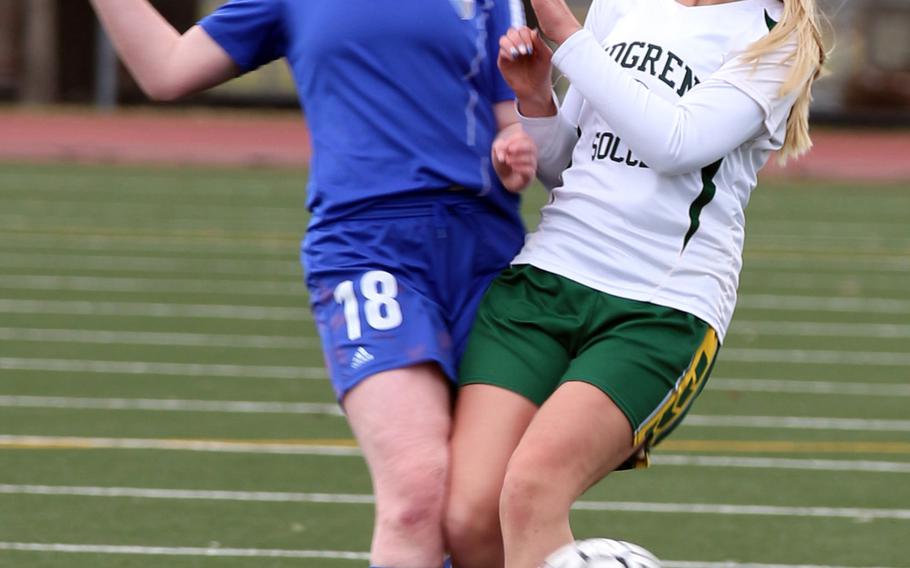 Yokota's Kendall Boone and Robert D. Edgren's Josie Dooley scrum for the ball during Saturday's girls soccer game, won by the visiting Panthers 4-0.