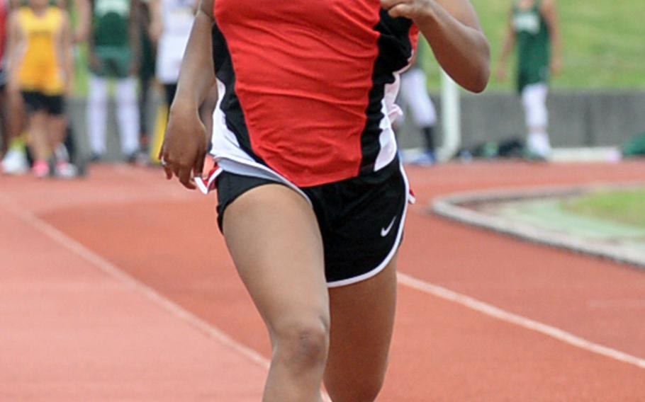 Okinawa Christian's Tia Calvin pushes toward the finish of the 100 during Saturday's Okinawa track and field meet. Calvin won in 13.41 seconds.