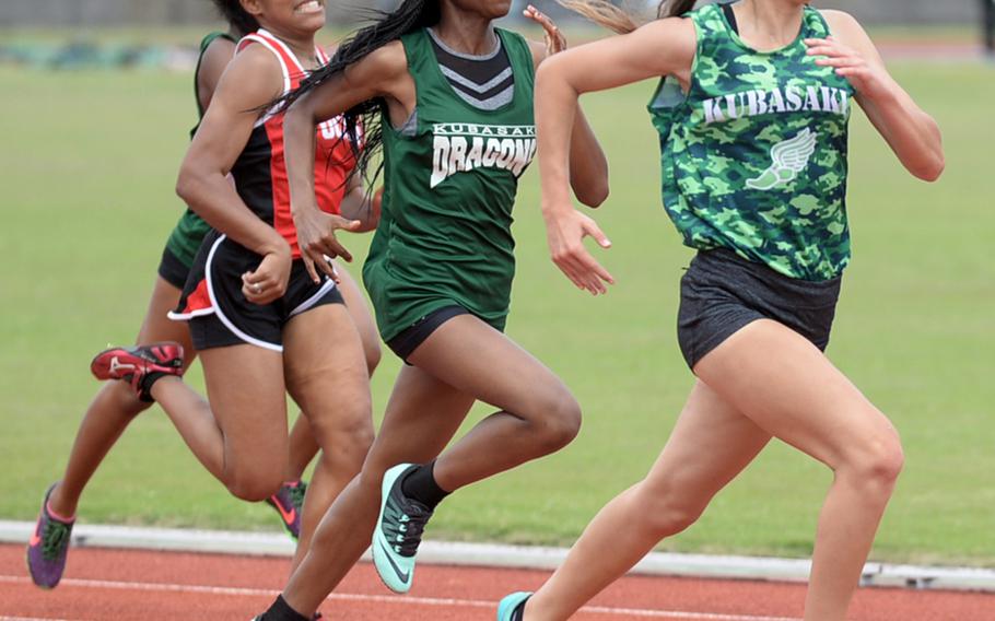 Kubasaki's Samantha Fermin leads the pack toward the finish of the 200 during Saturday's Okinawa track and field meet. Fermin won in 27.64 seconds.