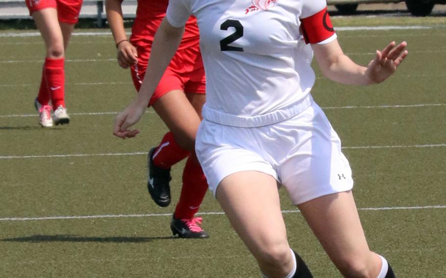 E.J. King's Natalie Shultz pushes the ball upfield against Nile C. Kinnick during Saturday's girls soccer match, won by the Red Devils 1-0.