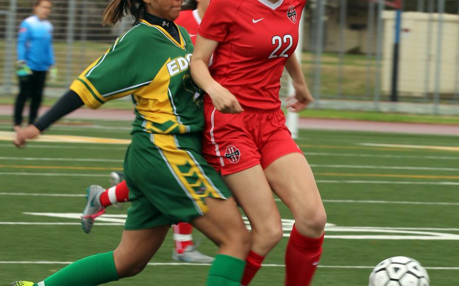 Robert D. Edgren's Sopheary Soun battles Nile C. Kinnick's Maggie Arnold for the ball during Saturday's Japan girls soccer match, won by the Red Devils 4-0.