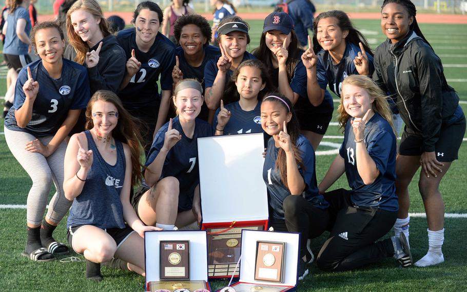 Osan players gather round the championship hardware following Saturday's Korea Blue Division girls soccer tournament finals. The Cougars edged Seoul Foreign 3-1 in a penalty-kick shootout for their second straight title.