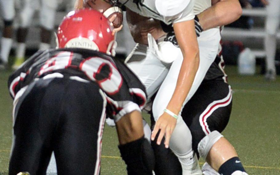 Kubasaki quarterback Skyler Klimek finds himself hemmed in by Nile C. Kinnick's defense. Klimek was 8-for-25 for 93 yards passing.