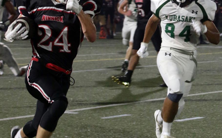 Nile C. Kinnick running back Aaron Peterson outruns Kubasaki defender Jaylan Penney. Peterson ran for 67 yards and a touchdown on eight carries.