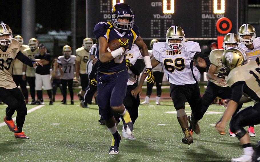 Guam's Makoa Bamba carries the ball against Tiyan during Friday's season-opening game. The Panthers edged the Titans 8-7.