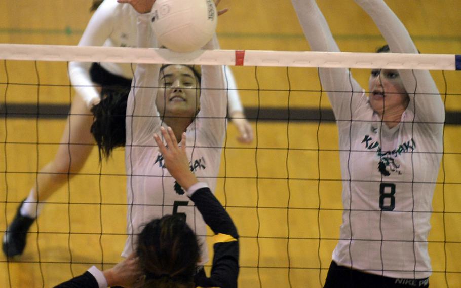 Kubasaki's Mimi Larry goes up to block a shot by Kadena's Val Robles alongside teammate Abbi Robinson during Tuesday's high school volleyball match, won by the Dragons 25-21, 25-15, 25-20.