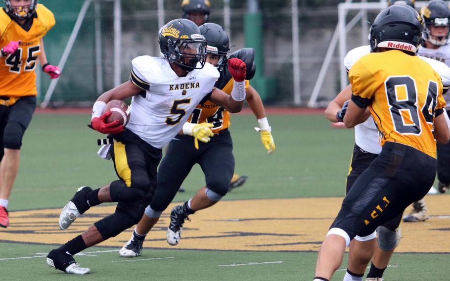 Kadena running back Eric McCarter looks for daylight against the American School In Japan defense. The junior accounted for 343 all-purpose yards and six touchdowns as the Panthers avenged last year's Far East Division I title-game loss to the Mustangs on Saturday, routing ASIJ 67-26.