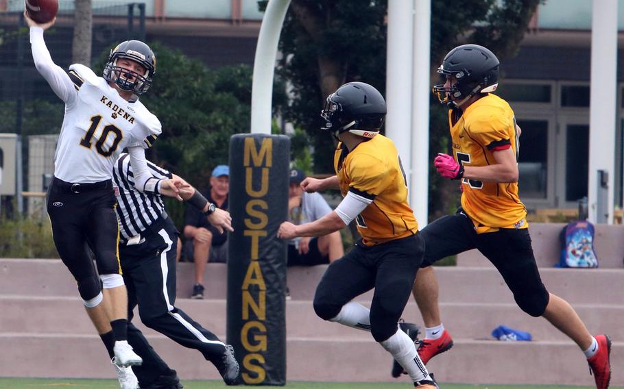 Kadena quarterback Cody Sego throws out of the end zone with two American School In Japan defenders chasing him. The Panthers avenged last year's Far East Division I title-game loss to the Mustangs on Saturday, routing ASIJ 67-26.