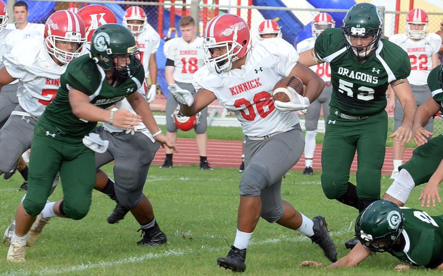 Nile C. Kinnick running back Harry Cheng blasts his way through Kubasaki defenders. Cheng scored three rushing touchdowns as the Red Devils won for the first time in school history on Okinawa, downing the Dragons 24-3.