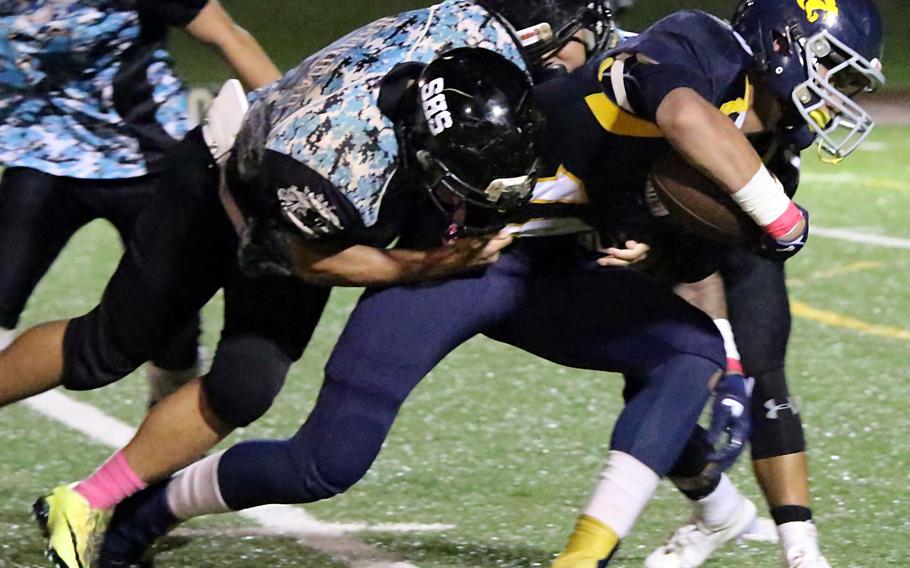 Makoa Bamba drags a Southern defender with him for yardage for Guam High.