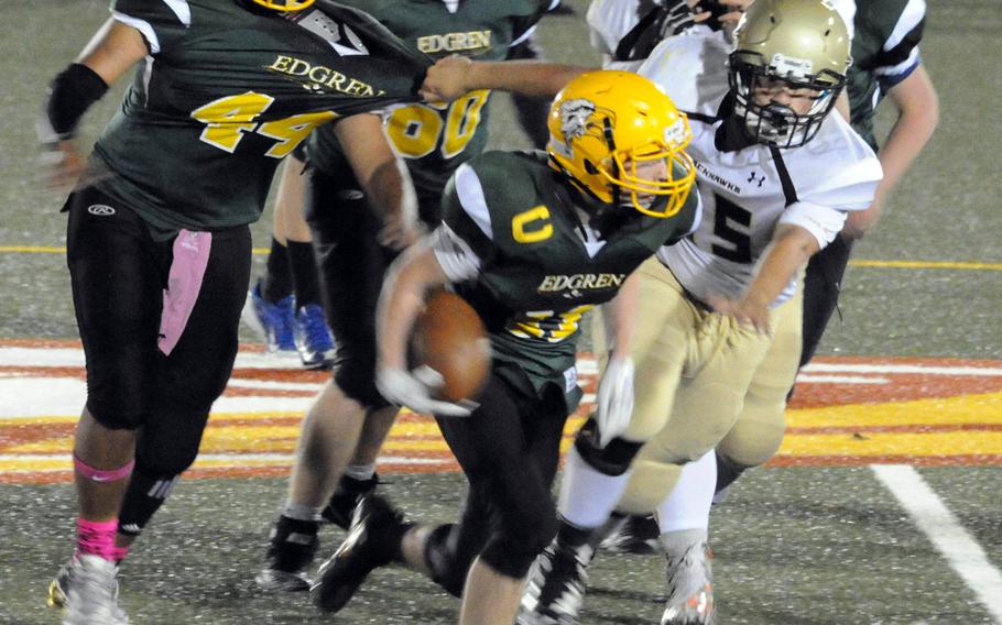 Robert D. Edgren ball carrier Matt Keating looks to get clear of the pack.