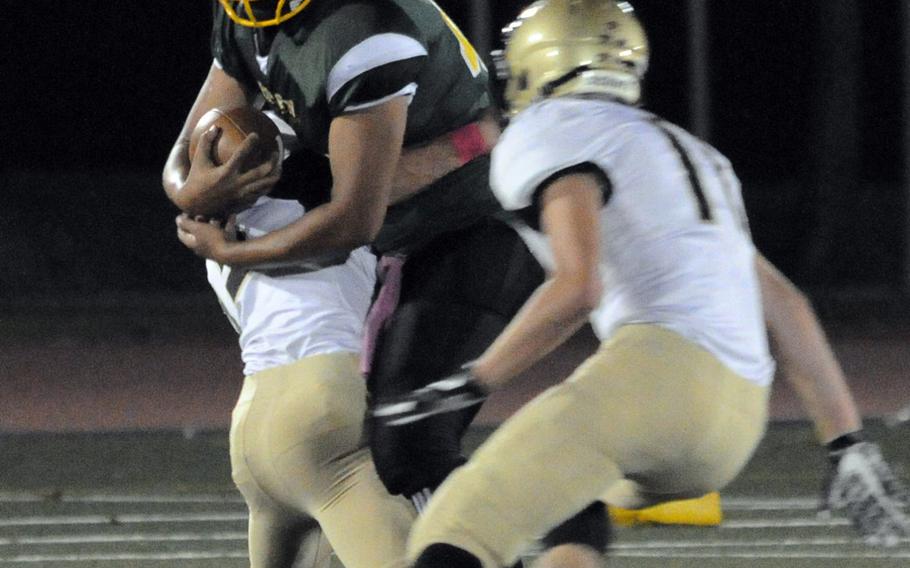 Robert D. Edgren running back Elijah Pugh gets wrapped up by a pair of Humphreys defenders.