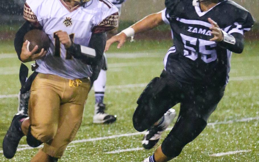 Matthew C. Perry ball carrier Elijah Lebron tries to scat past Zama defender Justin Brown.